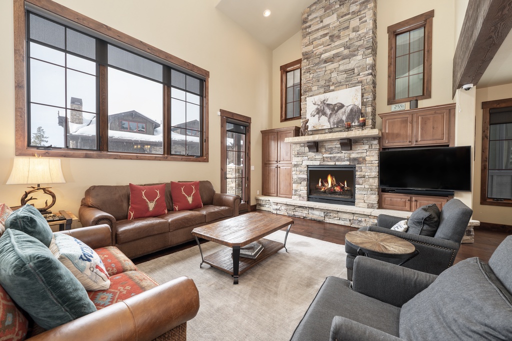 Cozy up by the crackling stone fireplace as you sink into plush leather sofas, enjoying mountain views through expansive windows.