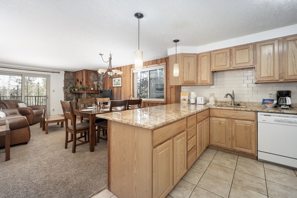Gather in your spacious kitchen with granite counters and island, flowing seamlessly into the cozy living and dining areas for memorable meals together.