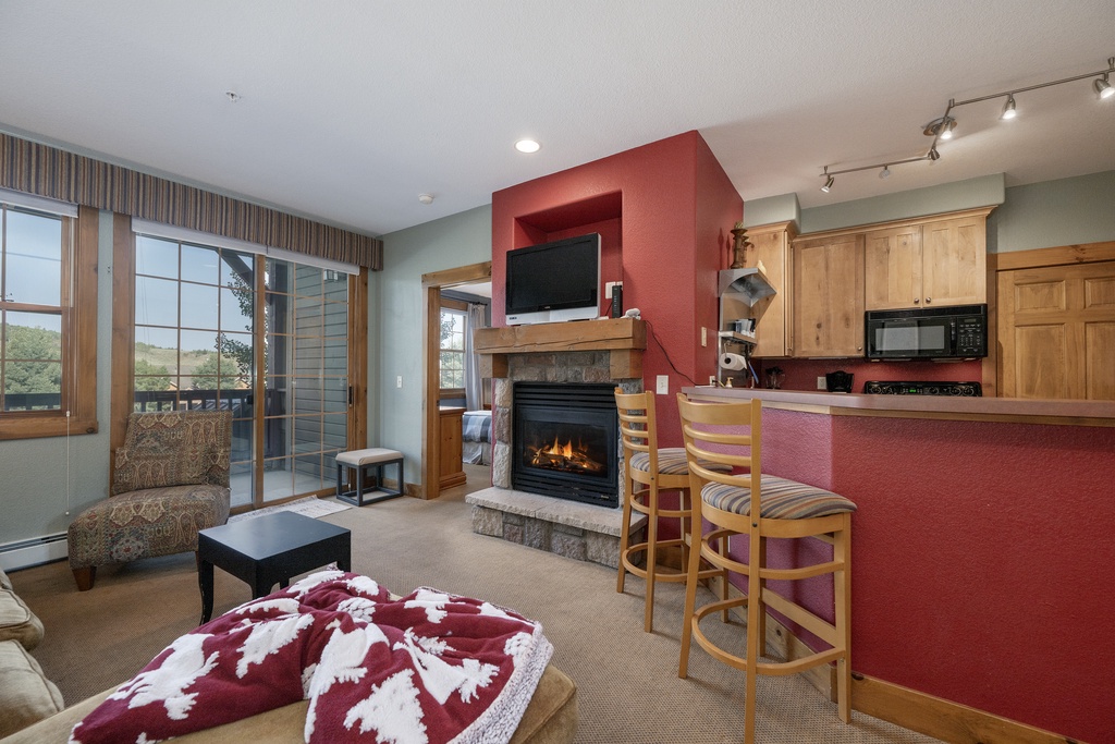 Cozy up by your fireplace while dinner simmers in the full kitchen, then unwind with mountain views from your private balcony.