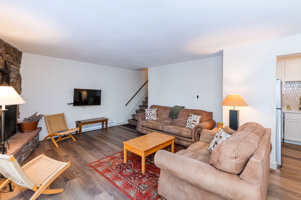 Settle into your cozy living room with plush leather sofas, warm fireplace, and flat-screen TV for perfect evenings in.