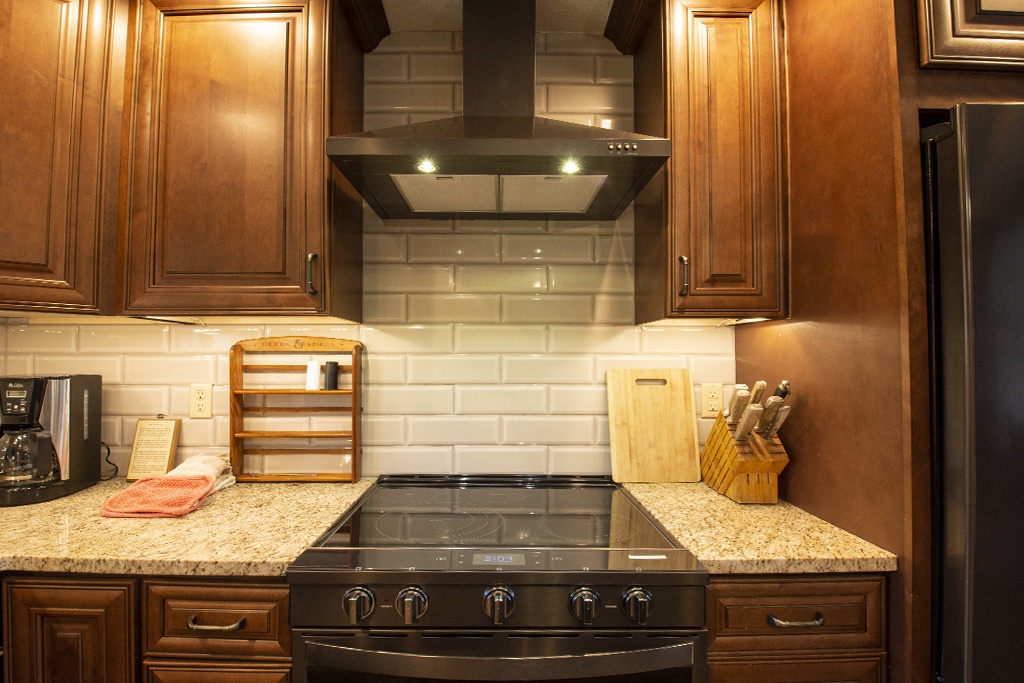 Your gourmet kitchen features granite counters, rich cabinetry, and premium appliances ready for your culinary adventures.