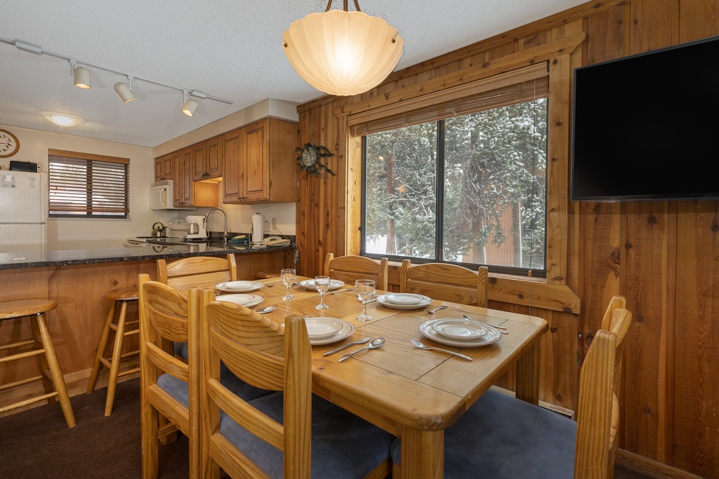 Gather around your cozy dining table for memorable meals in this warm wood-paneled space with mountain views.