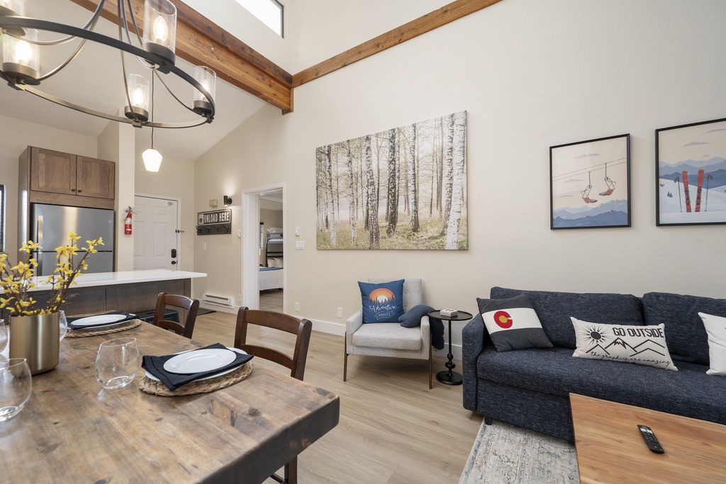 Your open-concept living space blends rustic wood beams with modern comfort, creating the perfect spot to unwind after mountain adventures.