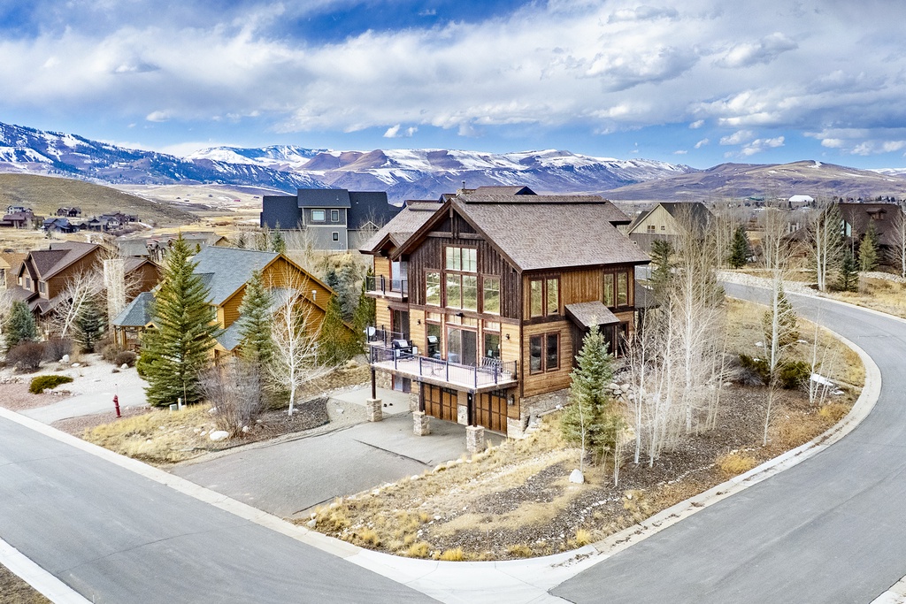 Modern mountain home showcases contemporary alpine architecture amid stunning snow-capped peaks in this prestigious neighborhood.