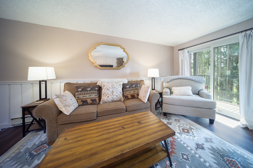 Sink into plush seating while natural light streams through your private balcony doors, creating the perfect spot to unwind.