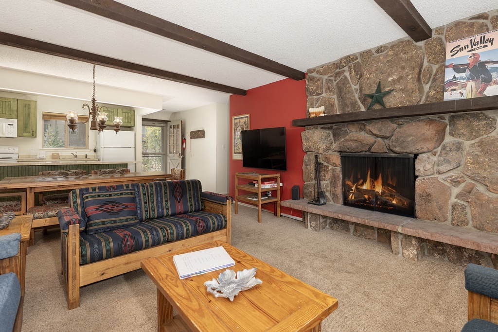 Cozy up by your stone fireplace in this welcoming living space with rustic charm and modern comfort.