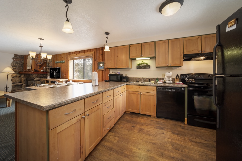 Your fully equipped kitchen features warm wood cabinets, granite counters, and all the essentials for preparing memorable meals together.