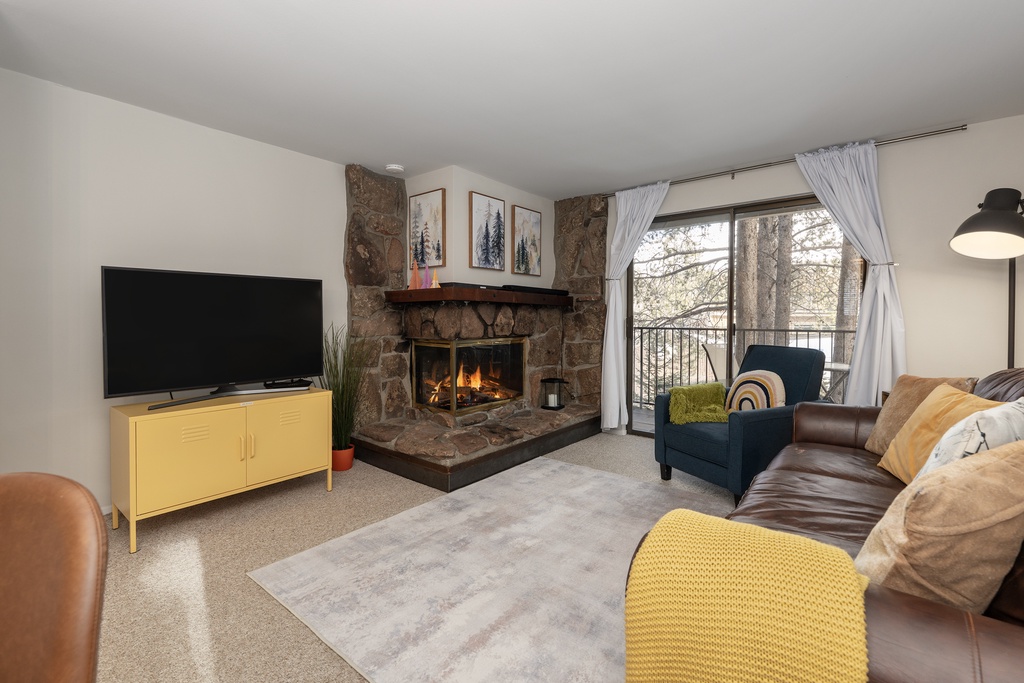 Cozy up by your crackling stone fireplace while enjoying mountain views from this inviting living space with modern amenities.