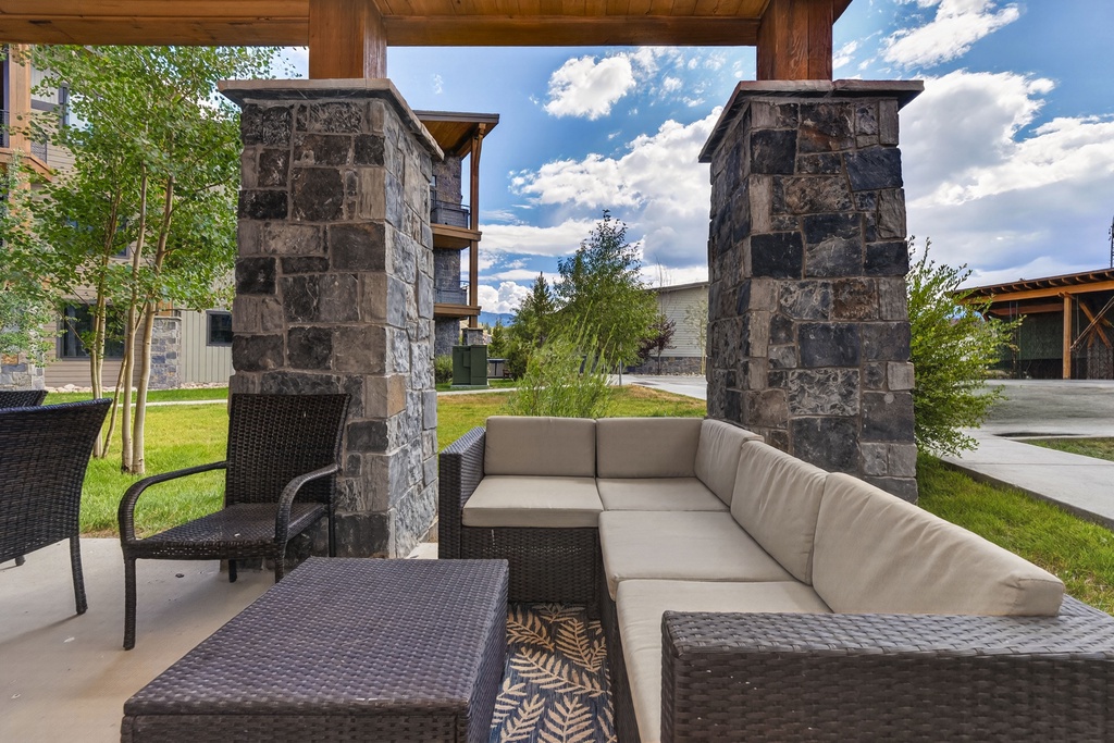 Unwind in your own covered patio retreat, where plush outdoor seating invites you to relax beneath the open sky and take in the peaceful mountain air.