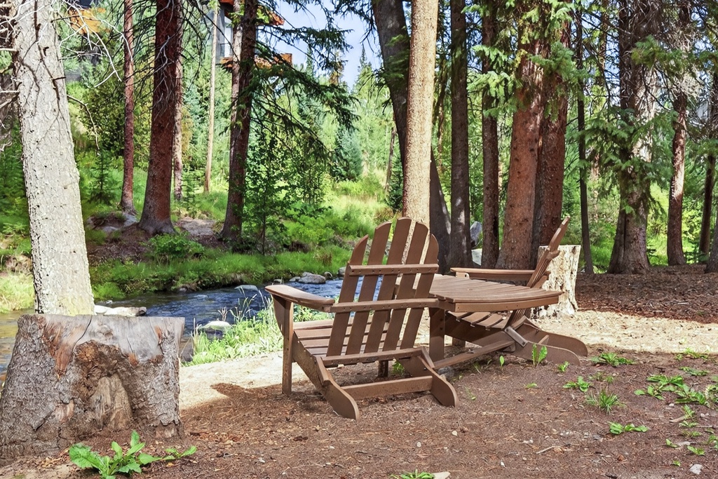 Relax in your private creekside seating area surrounded by towering pines, where the gentle sounds of flowing water and birdsong create your perfect mountain escape.