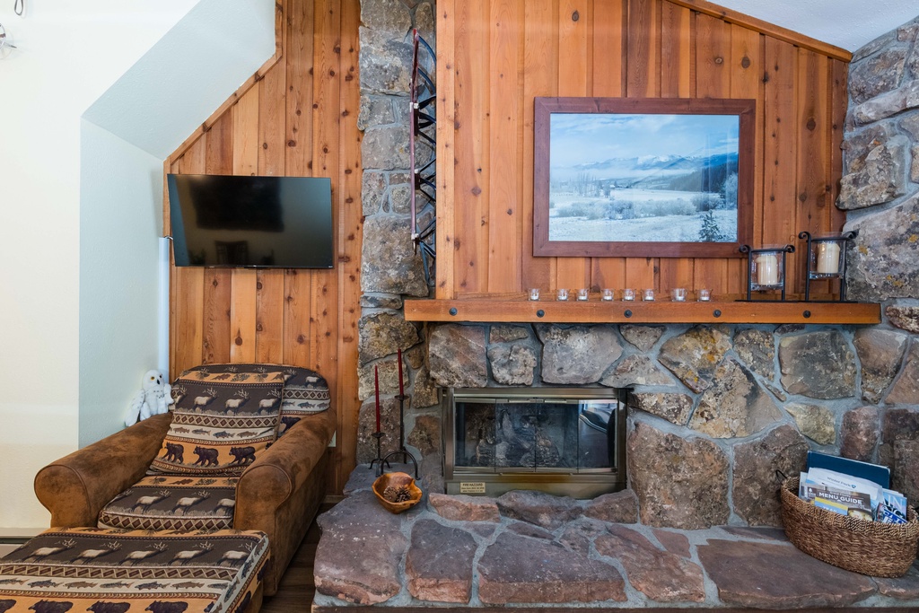Cozy up by your rustic stone fireplace with mountain views, perfect for unwinding after alpine adventures.