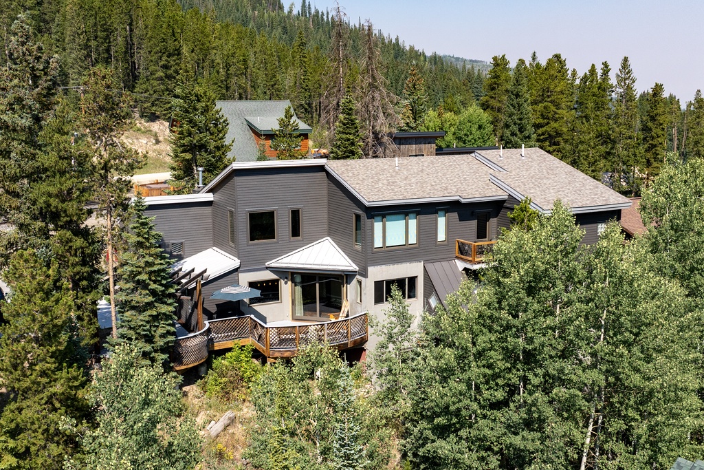 Stunning mountain property nestled among towering evergreens with expansive forest views and natural privacy.