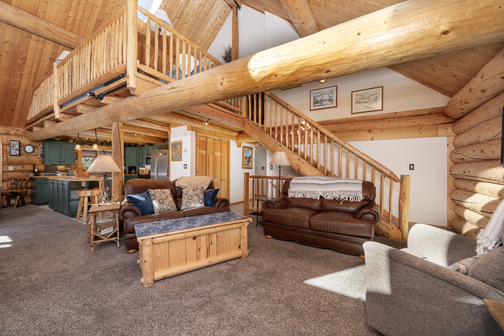 Sink into plush leather sofas surrounded by warm log beams and rustic charm in this inviting living space.