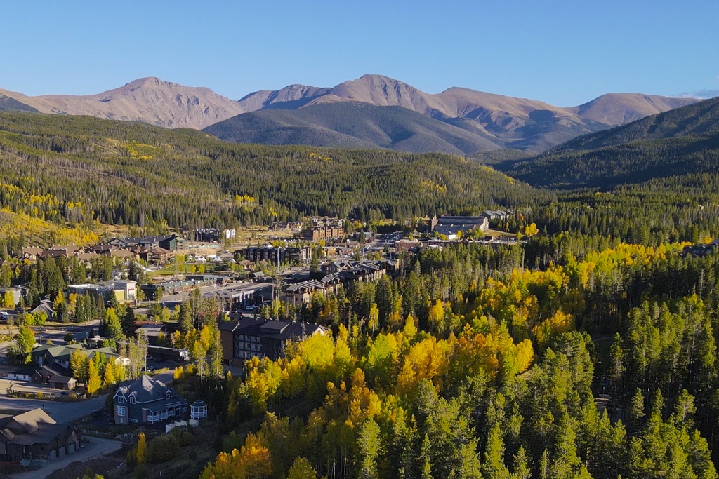 Nestled in a mountain valley, this scenic community is surrounded by evergreen forest and golden aspen trees with majestic peaks rising in the distance.