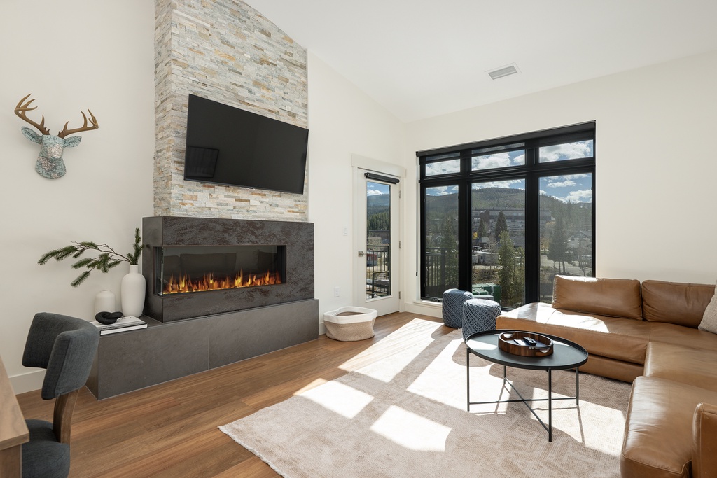 Sink into luxurious leather seating by your modern fireplace while mountain views frame your perfect retreat.
