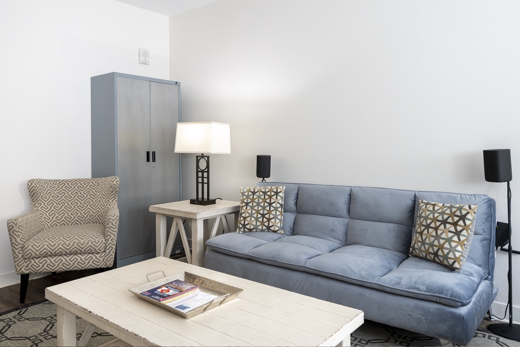 Sink into soft blue cushions and unwind in your stylish living space, perfectly appointed with cozy seating and thoughtful touches.