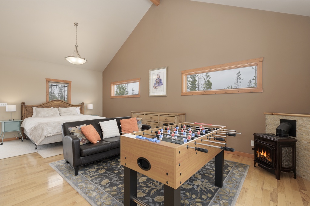 Your spacious retreat combines comfort with play—unwind by the fireplace or challenge friends to foosball in this cozy bedroom suite.