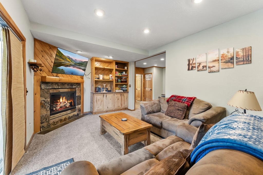 Sink into plush seating at 279 Shorewood Drive while the stone fireplace crackles warmly. Your mountain retreat features rustic charm with modern comfort.