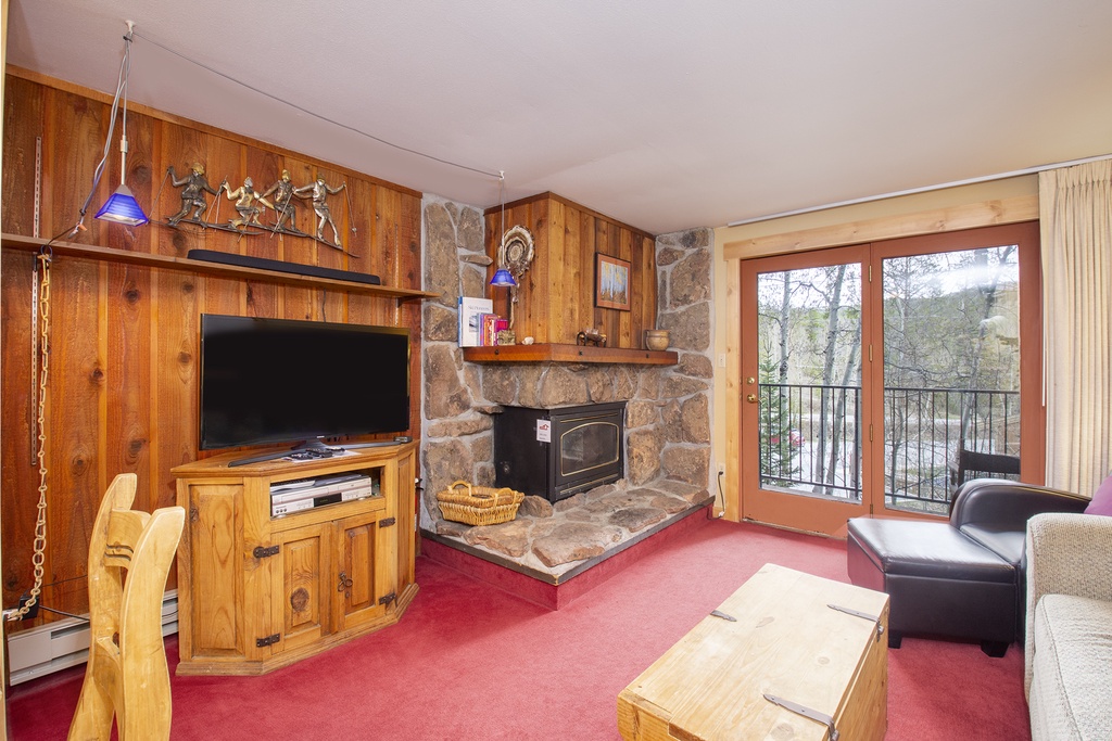 Cozy up by your stone fireplace while watching TV, then step onto your private balcony to enjoy peaceful tree views.