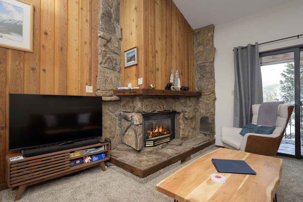 Cozy up by your crackling stone fireplace while snow falls outside your window, creating the perfect mountain retreat atmosphere.