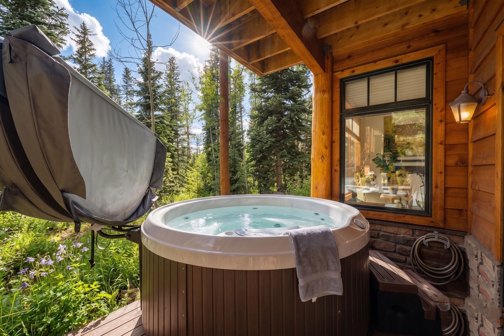 Soak in your private hot tub while snow glistens around you, warming up as mountain sunlight filters through towering evergreens.