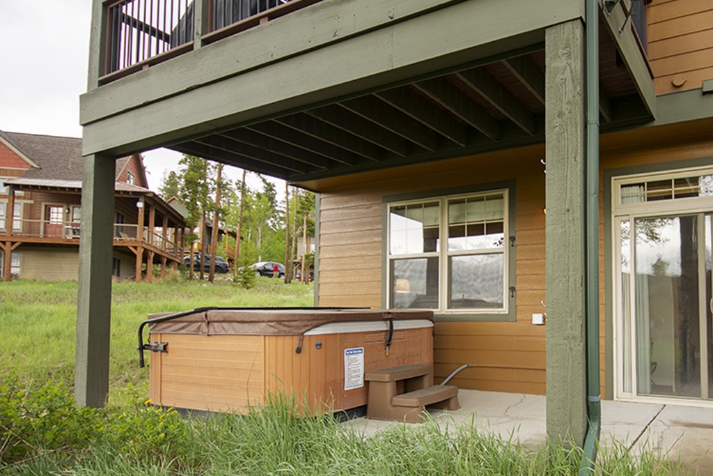 Relax in your private hot tub beneath the covered deck - the perfect spot to unwind after a day of adventures.