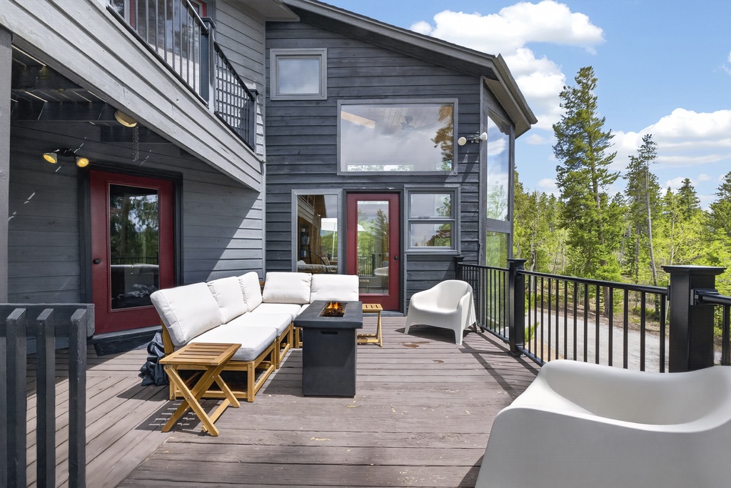 Relax on the spacious deck with plush lounge seating and soak in peaceful forest views from your private outdoor retreat.