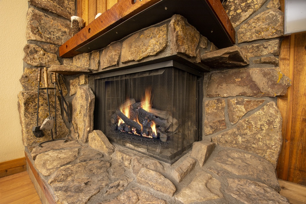 Cozy up by your rustic stone fireplace where crackling flames create the perfect ambiance for mountain evenings.