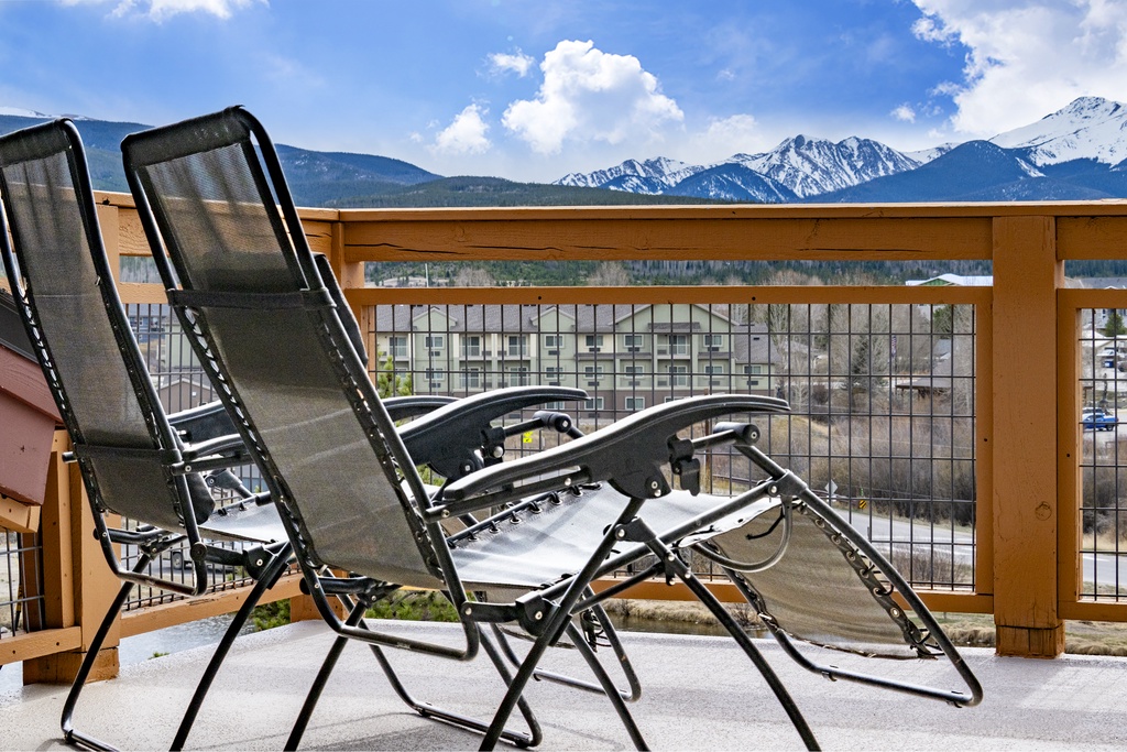 Unwind in comfortable lounge chairs on your private balcony, where stunning mountain vistas create the perfect backdrop for morning coffee or evening relaxation.