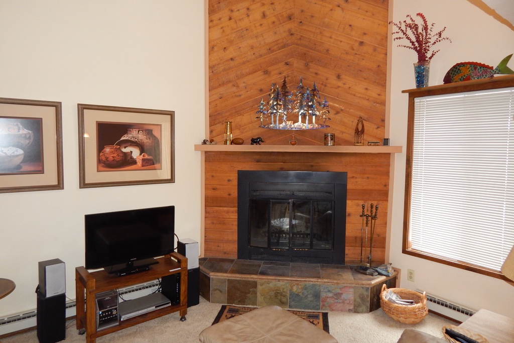 Cozy up by your private fireplace while enjoying your favorite shows on the flat-screen TV in this warm, inviting living space.