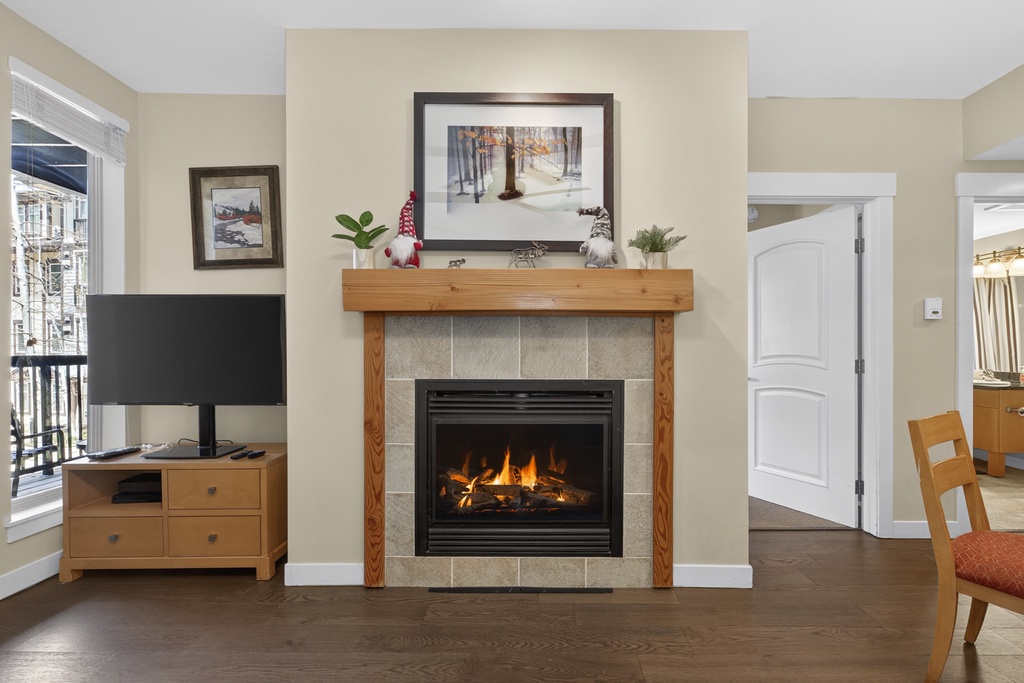 Cozy up by your own crackling fireplace—perfect for mountain evenings. The warm living space includes a flat-screen TV, tasteful decor, and plenty of room to relax after exploring.