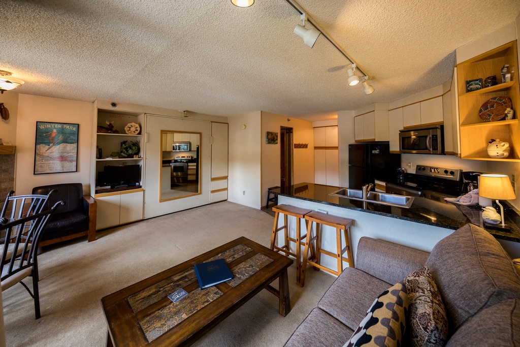 Your open-plan living space flows seamlessly from kitchen to lounge, perfect for preparing meals while staying connected with your group.