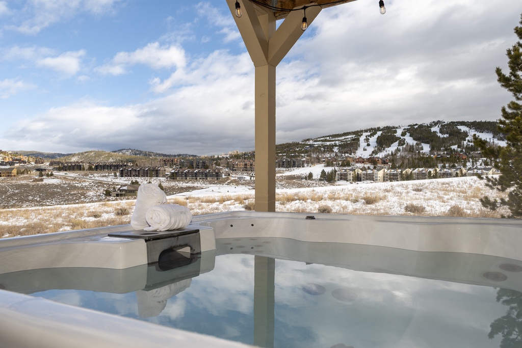 Soak in your private hot tub while gazing at snow-capped mountains and ski slopes stretching across the valley.