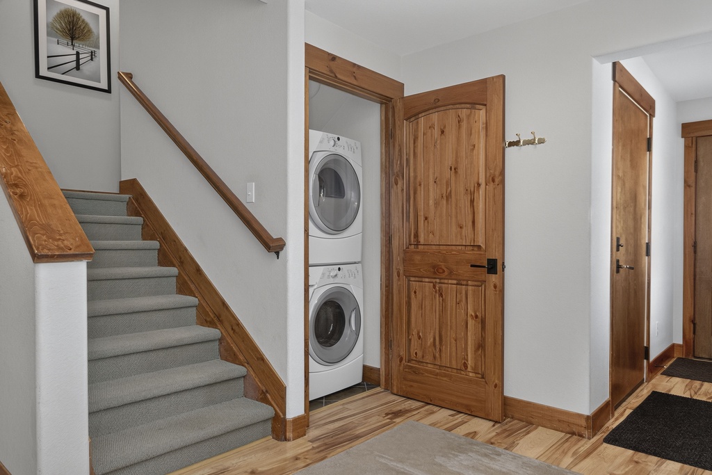 Your vacation home includes a convenient stacked washer and dryer, making packing light easy. Bright entryway with natural wood accents welcomes you home after mountain adventures.