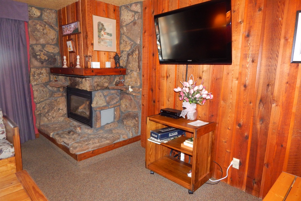 Unwind by your cozy stone fireplace while enjoying your favorite shows on the flat-screen TV in this warm, wood-paneled retreat.