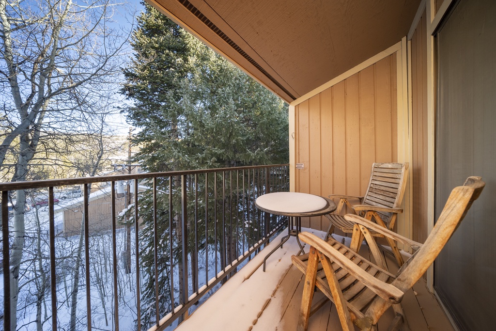 Step onto your private balcony where warm wood meets winter wonderland—sip morning coffee while snow-dusted evergreens frame your peaceful retreat.