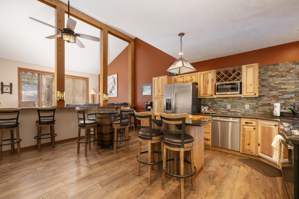 Your fully equipped kitchen at Mountainside B-20 awaits with rustic charm, featuring a cozy breakfast bar and ample space for culinary adventures.
