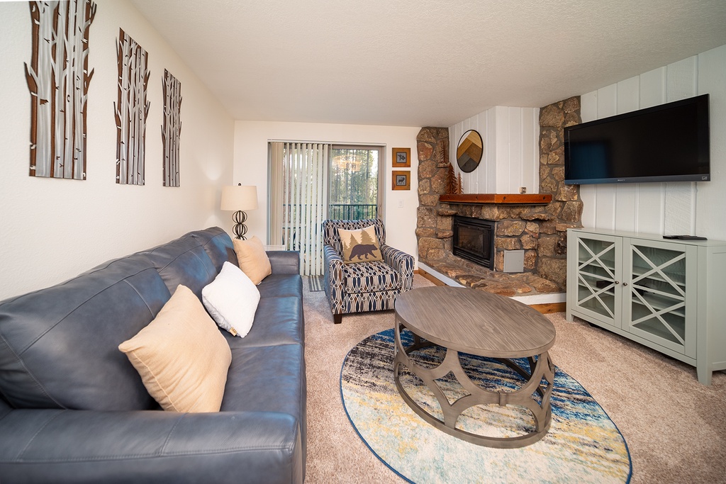 Sink into the plush leather sofa while your fireplace crackles nearby, creating the perfect backdrop for cozy evenings watching your favorite shows.