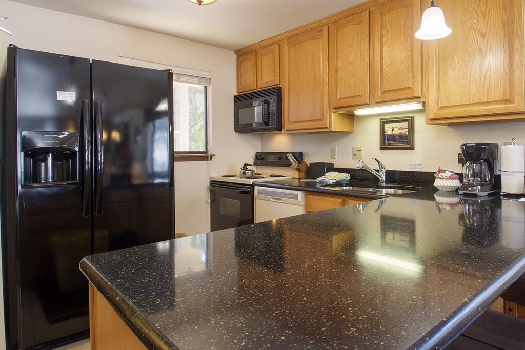 Your fully equipped kitchen features granite countertops, stainless steel appliances, and everything you need to prepare memorable meals during your stay.