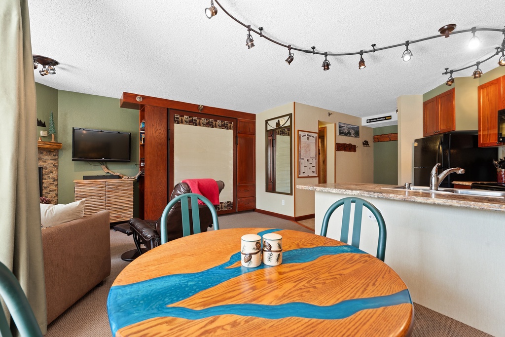 Relax in your open-concept living space with a fully equipped kitchen, cozy seating, and a welcoming dining area—perfect for unwinding after a day of adventure.