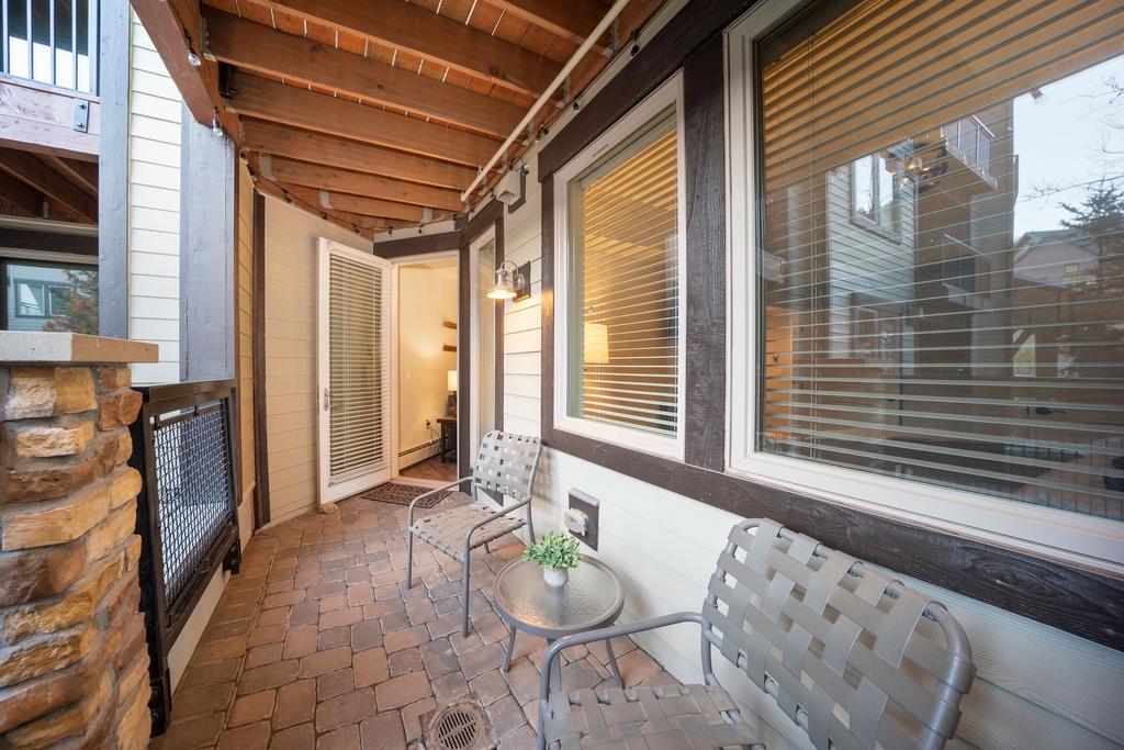 This charming covered patio offers your own peaceful retreat with comfortable seating and warm lighting—perfect for morning coffee or unwinding after a day of adventure.