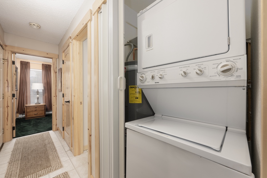 Your in-unit laundry setup makes extended stays effortless, with a convenient stacked washer and dryer tucked away in your private hallway.