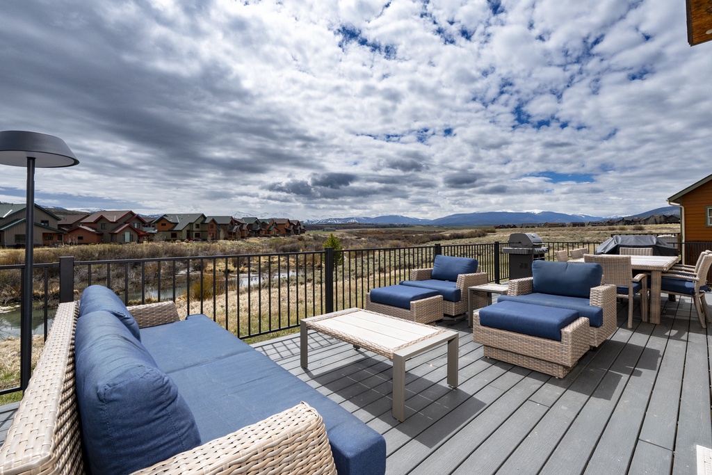Spacious deck overlooking mountain vistas and open landscape, perfect for morning coffee or evening relaxation with comfortable outdoor seating and peaceful views.