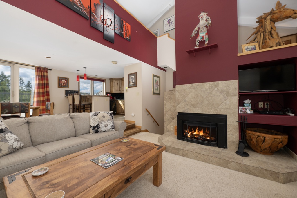 Cozy up in your spacious living room where crackling flames and mountain views create the perfect retreat after a day of adventure.