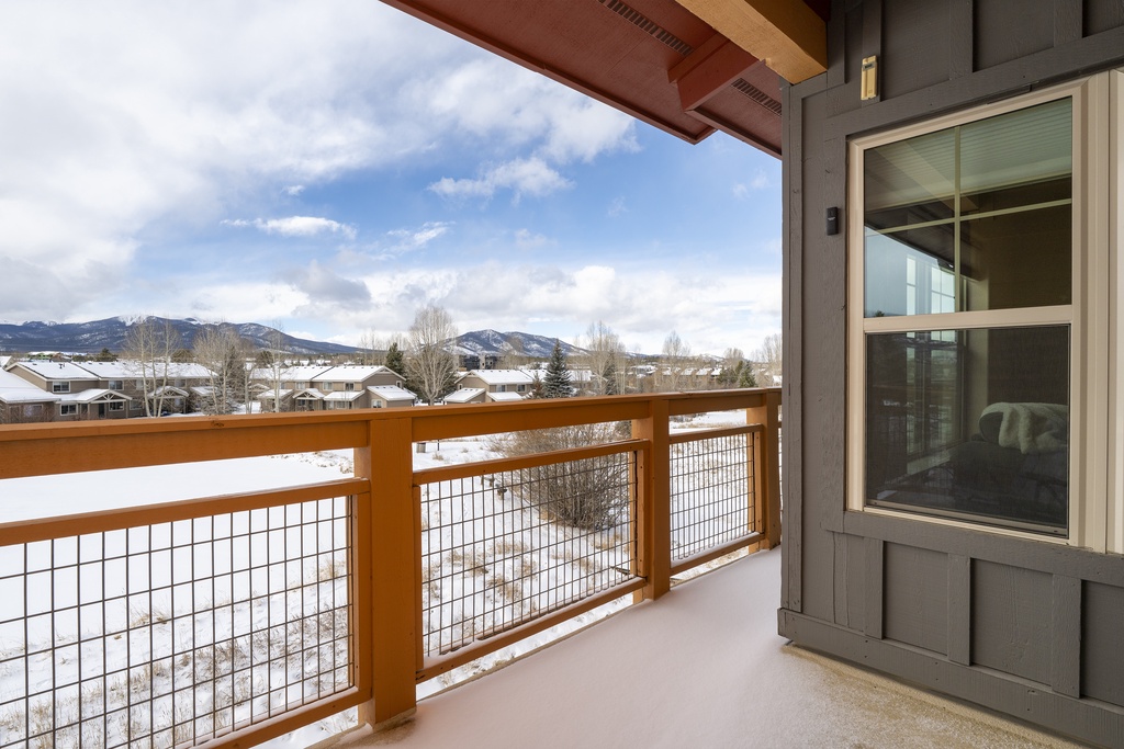 Step onto your private balcony and soak in breathtaking mountain views while winter snow blankets the peaceful neighborhood below.