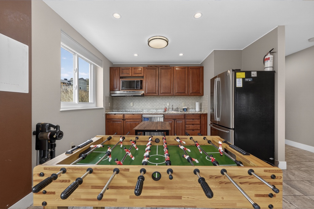 Challenge your friends to a foosball match in this open-concept space where fun meets functionality, complete with a full kitchen for game-day snacks.