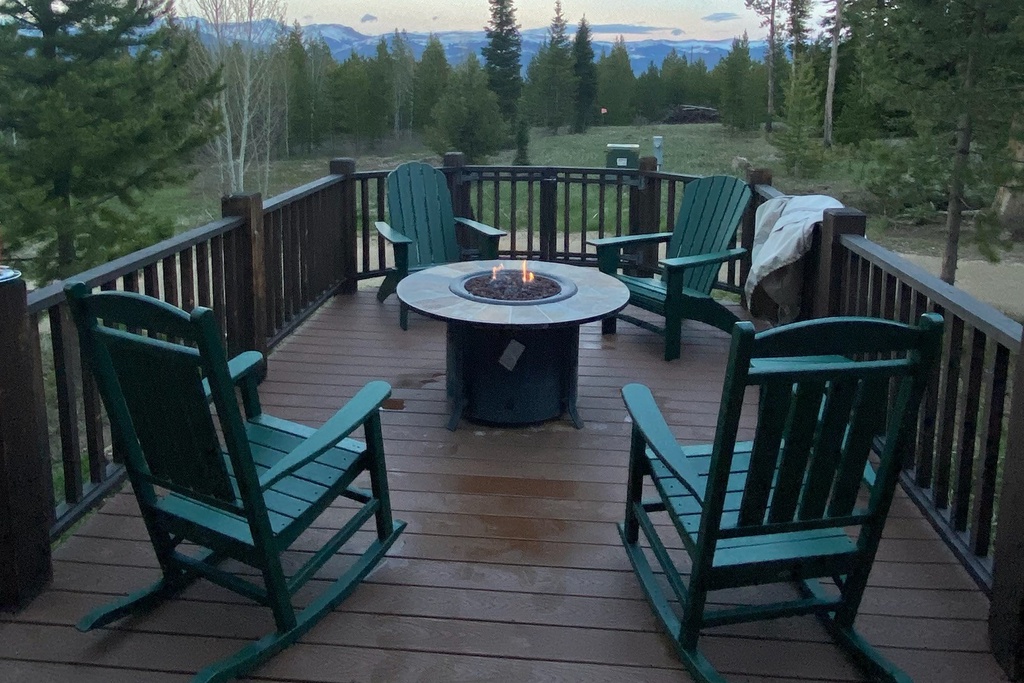 Gather around this cozy fire pit with mountain views stretching beyond the forest canopy.