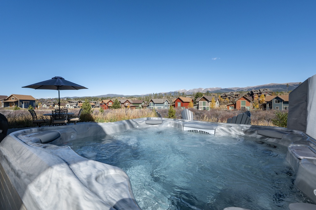 Soak in the bubbling hot tub while taking in stunning mountain and neighborhood views on this peaceful outdoor deck.