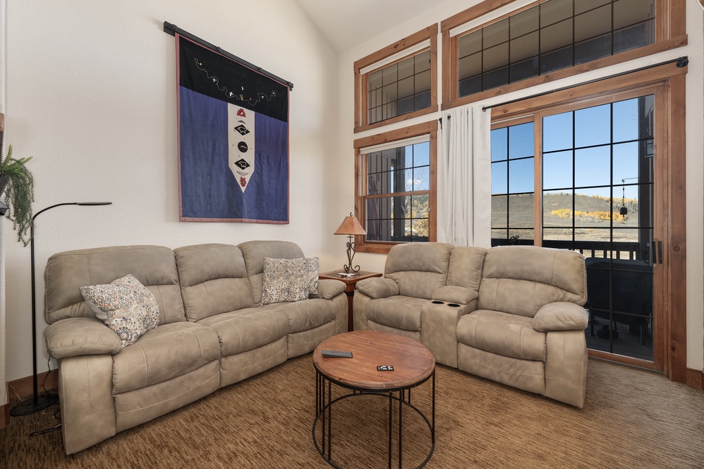 Sink into plush sofas and unwind in your cozy living room, where mountain views frame every relaxing moment through large windows.