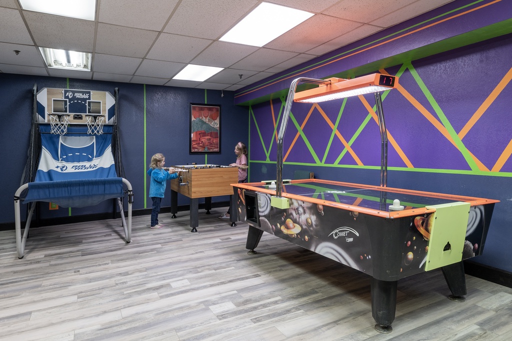 Challenge your friends to a game of air hockey or test your basketball skills in this vibrant entertainment space designed for friendly competition and fun.